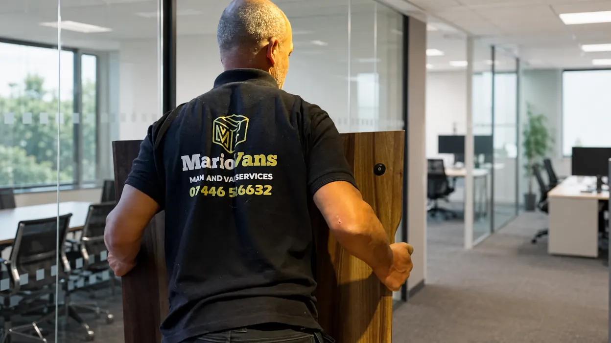MarioVans team member moving office furniture in Bedford